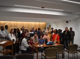 Audience members and presenters of the proposed immigrant welcome center pose with the Johnson County Board of Supervisors June 4, 2025.