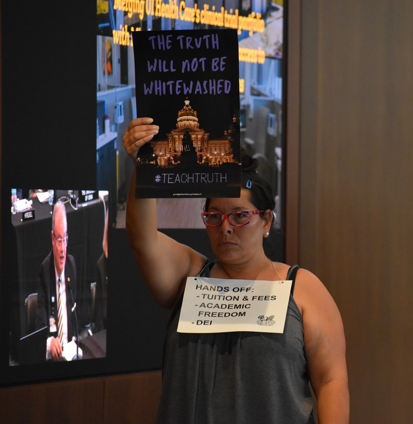 Protestor A protestor holds a sign depicting the Iowa Capitol accompanied by the words "The truth will not be whitewashed" at the Iowa Board of Regents meeting Wednesday, June 11.