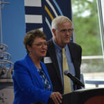 St. Ambrose President Amy Novak and Mount Mercy President Todd Olson celebrate the first phase of their universities' merger with a symbolic signing Friday, June 27.