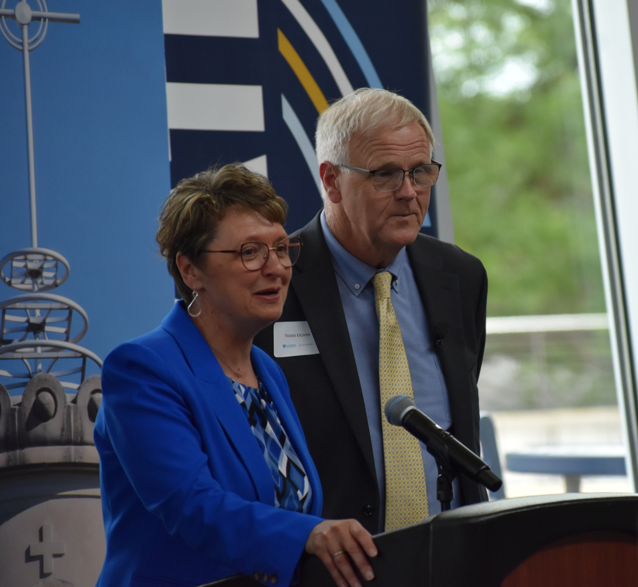 University president St. Ambrose President Amy Novak and Mount Mercy President Todd Olson celebrate the first phase of their universities' merger with a symbolic signing Friday, June 27.