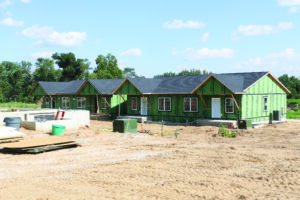 CDBG-funded derecho recovery duplexes are shown under construction at Dows Farm. The duplexes are 776-square-foot zero-lot homes with two bedrooms, one bath and a one-stall garage, plus an additional 514 square feet with one bedroom and one bath in the basement if finished. CREDIT RICHARD PRATT