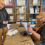 IC Repair volunteer Chris Anderson sharpens a knife for an attendee April 4.