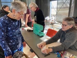 A volunteer demonstrates the mending process to an attendee at IC Repair's April 4 event.