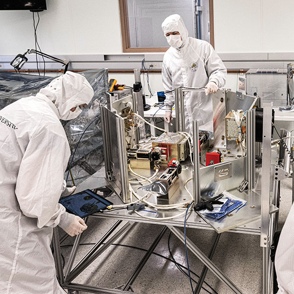 Members of the TRACERS team in the clean room at Van Allen Hall.