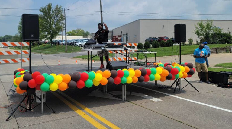 DJ Tone Da Boss of T1 Entertainment takes the stage during the July 12 Unity Exchange on Keokuk Street in the So. of 6 Iowa City Business District.