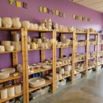 A wall-length shelving unit teems with pottery waiting to be painted at The Potter's Obsession, 1941 51st St. NE Cedar Rapids.
