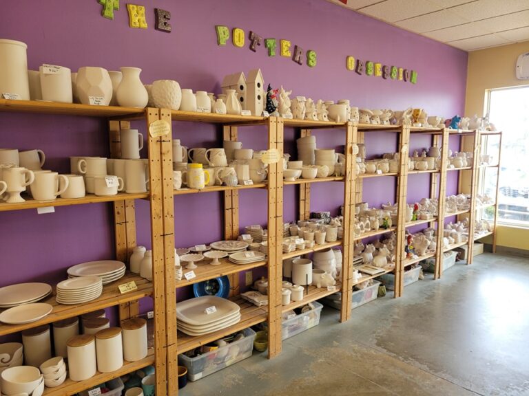 A wall-length shelving unit teems with pottery waiting to be painted at The Potter's Obsession, 1941 51st St. NE Cedar Rapids.