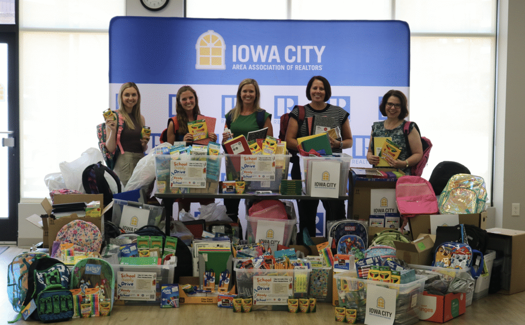 ICAAR’s Community Outreach members pose with donated school supplies in August 2025. From left: Megan Flewellyn, ICAAR CEO; Kayla Fisher, Jessica Campbell, Sarah Miller and Tracey Molina