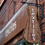 Textiles' store sign at 105 S. Dubuque St. in the Ped Mall.