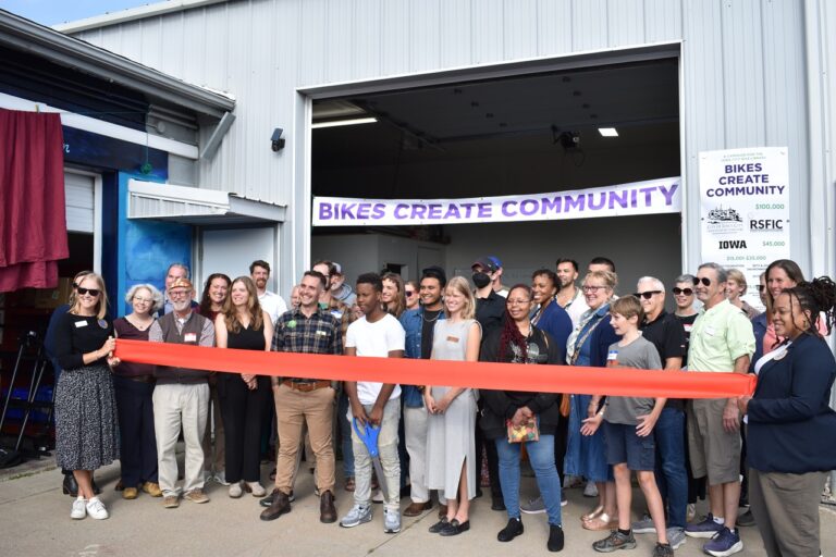 Iowa City Bike Library staff, volunteers, board members and participants cut the ribbon on the new youth hub at the organization's Bikes Create Community campaign Sept. 4.