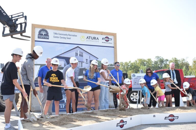 Students from the Tiffin school district are all grins as they don hardhats and hold shovels for the groundbreaking of the city's $10 million recreation center on Sept. 16, 2025.