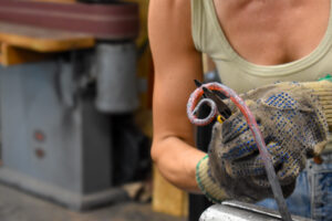 Fenokee co-founder Annie McElree works in the forge in her and Mr. Hart’s workshop Sept. 26, 2025. CREDIT ANNIE SMITH BARKALOW