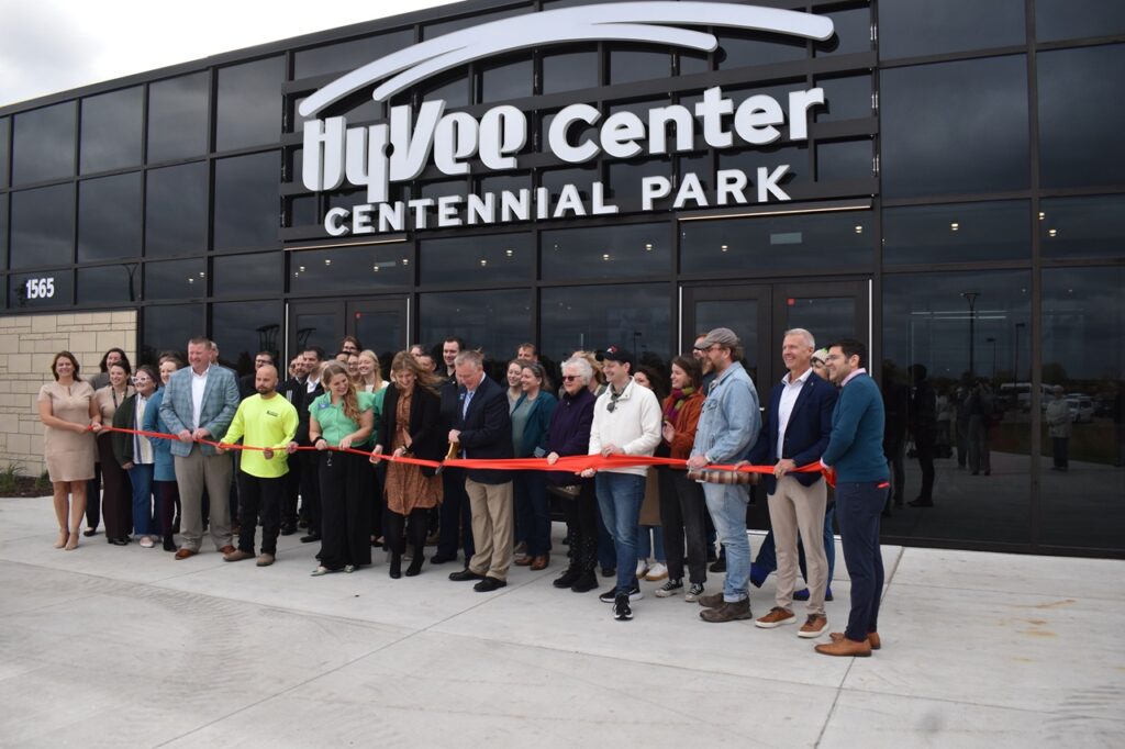 Crosspark Road Hy-Vee District Store Director Elise Scheil and North Liberty Mayor Chris Hoffman, center, prepare to cut the ribbon to the new Hy-Vee Center and Amphitheater Oct. 21.