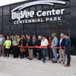 Crosspark Road Hy-Vee District Store Director Elise Scheil and North Liberty Mayor Chris Hoffman, center, prepare to cut the ribbon to the new Hy-Vee Center and Amphitheater Oct. 21.