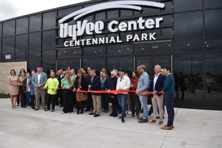 Crosspark Road Hy-Vee District Store Director Elise Scheil and North Liberty Mayor Chris Hoffman, center, prepare to cut the ribbon to the new Hy-Vee Center and Amphitheater Oct. 21.