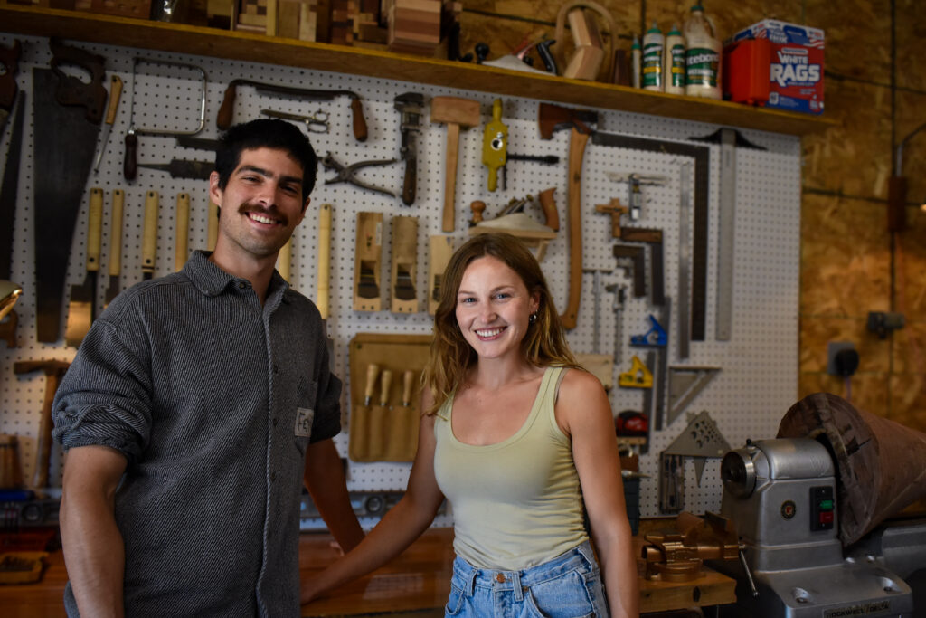 Drew Hart and Annie McElree of Fenokee furniture pose in their workshop in Cedar Rapids Sept. 26, 2025. CREDIT ANNIE SMITH BARKALOW