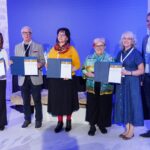 (Third from right) Cecilia Rokusek, NCSML president and CEO, and Stefanie Kohn, curator, display their award at the Živa Award ceremony.