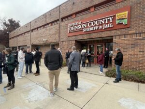 Several people linger outside the Johnson County Sheriff's Office following the sale.