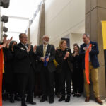 Executive Officer of University of Iowa's Department of Family and Community Medicine Dr. Jeff Quinlan (center) smiles after he cuts the ribbon on the new primary care clinic at 2751 Northgate Drive in Iowa City. To his left is UI Health Care CEO Brad Haws, and Vice President for medical affairs and Dean of the Carver College of Medicine Dr. Denise Jamieson stands to his right on Dec. 9, 2025.