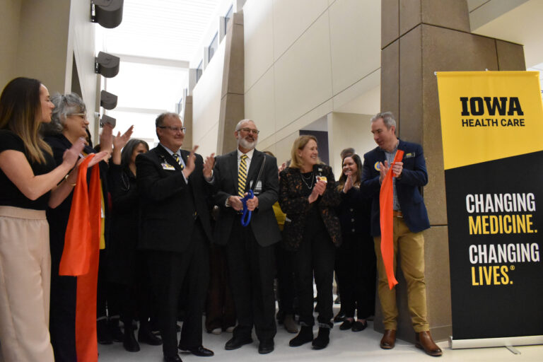 Executive Officer of University of Iowa's Department of Family and Community Medicine Dr. Jeff Quinlan (center) smiles after he cuts the ribbon on the new primary care clinic at 2751 Northgate Drive in Iowa City. To his left is UI Health Care CEO Brad Haws, and Vice President for medical affairs and Dean of the Carver College of Medicine Dr. Denise Jamieson stands to his right on Dec. 9, 2025.