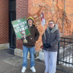 Starbucks baristas James Nordholm and Hayden Evans picket outside the Starbucks at 228 S. Clinton St. in Iowa City Dec. 17, 2025.