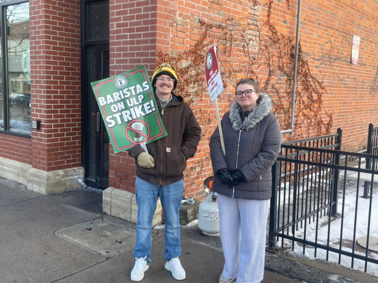 Starbucks baristas James Nordholm and Hayden Evans picket outside the Starbucks at 228 S. Clinton St. in Iowa City Dec. 17, 2025.