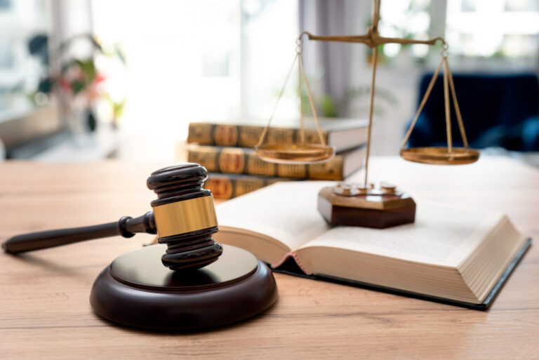Wooden gavel with books in background