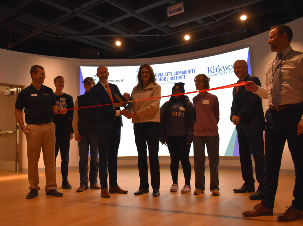 Iowa City Community School District Superintendent Matt Degner prepares to cut the ribbon on the JA Dream Accelerator with Christine Landa, JA Eastern Iowa's president, on Jan. 15, 2026.