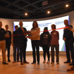 Iowa City Community School District Superintendent Matt Degner prepares to cut the ribbon on the JA Dream Accelerator with Christine Landa, JA Eastern Iowa's president, on Jan. 15, 2026.