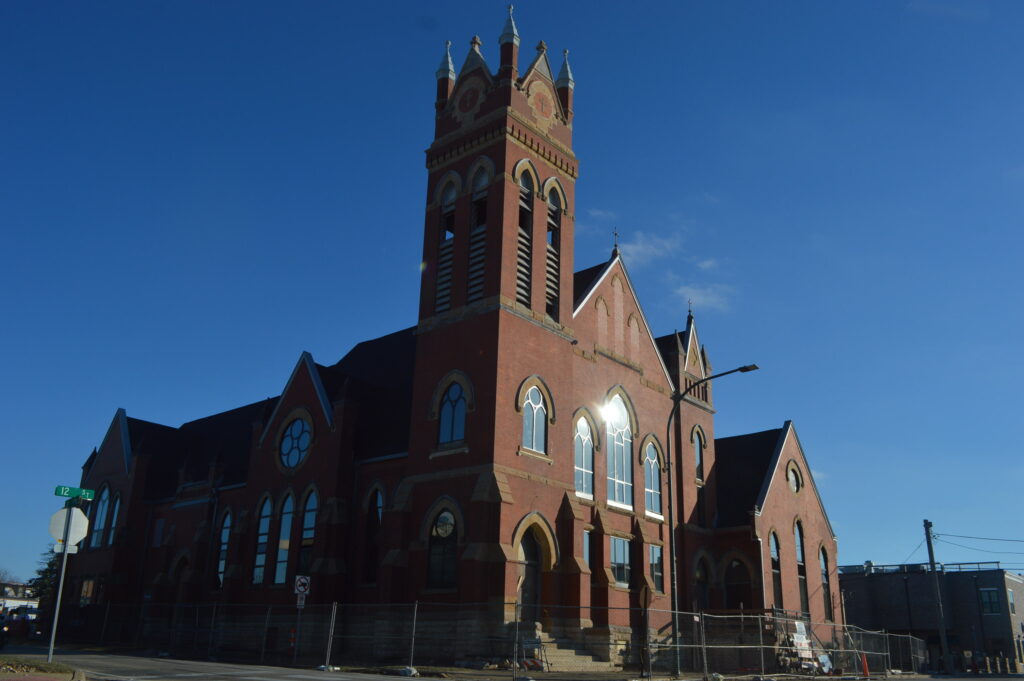 The former Methodist church in Marion, damaged during Iowa's 2020 derecho, is seen in January at the corner of Eighth Avenue and 12th Street. Redevelopment as Belltower Lofts is expected to be completed this summer, with 55 residential units. CREDIT CINDY HADISH