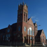The former Methodist church in Marion, damaged during Iowa's 2020 derecho, is seen in January at the corner of Eighth Avenue and 12th Street. Redevelopment as Belltower Lofts is expected to be completed this summer, with 55 residential units. CREDIT CINDY HADISH
