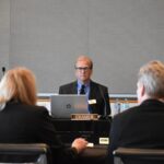Iowa Board of Regents President Robert Cramer (center) listens to a presentation by UI Health Care at the Levitt Center for University Advancement on the University of Iowa campus Feb. 25, 2026.