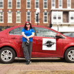 Brittany Erickson is shown with one of his cabs in downtown Washington, Iowa. CREDIT ANNIE SMITH BARKALOW