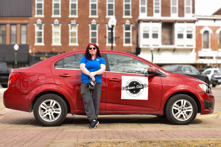 Brittany Erickson is shown with one of his cabs in downtown Washington, Iowa. CREDIT ANNIE SMITH BARKALOW