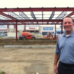 Todd Nelson, president and CEO of Frew Development Group’s Midwest Division, stands next to Westdale Town Center’s newest building, which will house Bath and Body Works and other retailers. CREDIT RICHARD PRATT