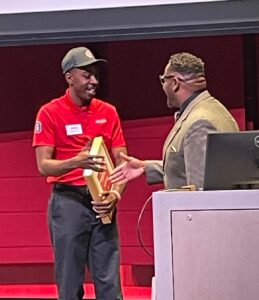 Juan Beard (left) accepts the Volunteer of the Year award from Iowa City Mayor Bruce Teague.